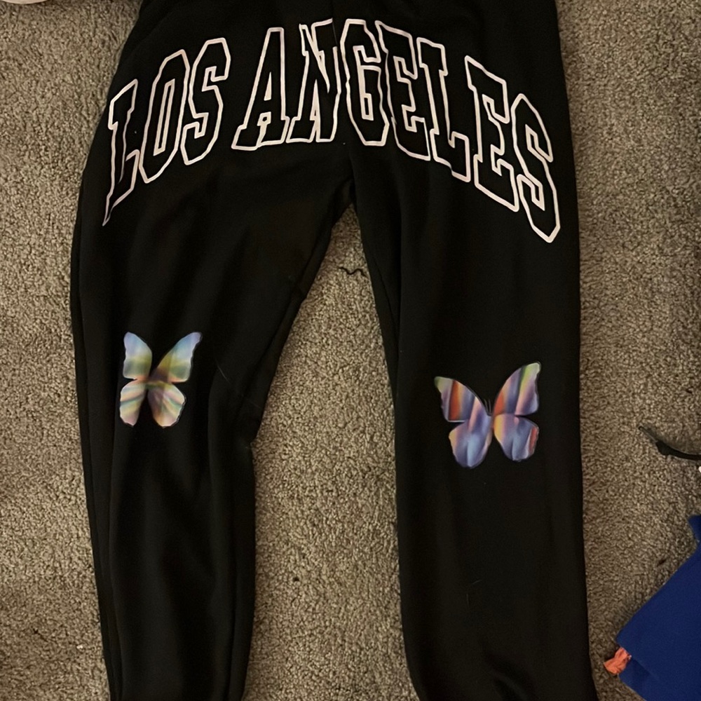 Black and white shein sweatpants, tight waste with butterflies on knees